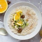 Bowl of porridge oats with orange fruit and nuts on top which can be made through an alternative recipe using flaxseed and ground almonds to make it ketogenic and paleo friendly