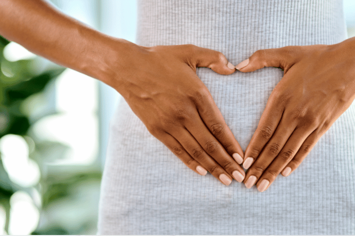 Gut microbiome Long COVID Picture of a woman holding her gut in Long COVID